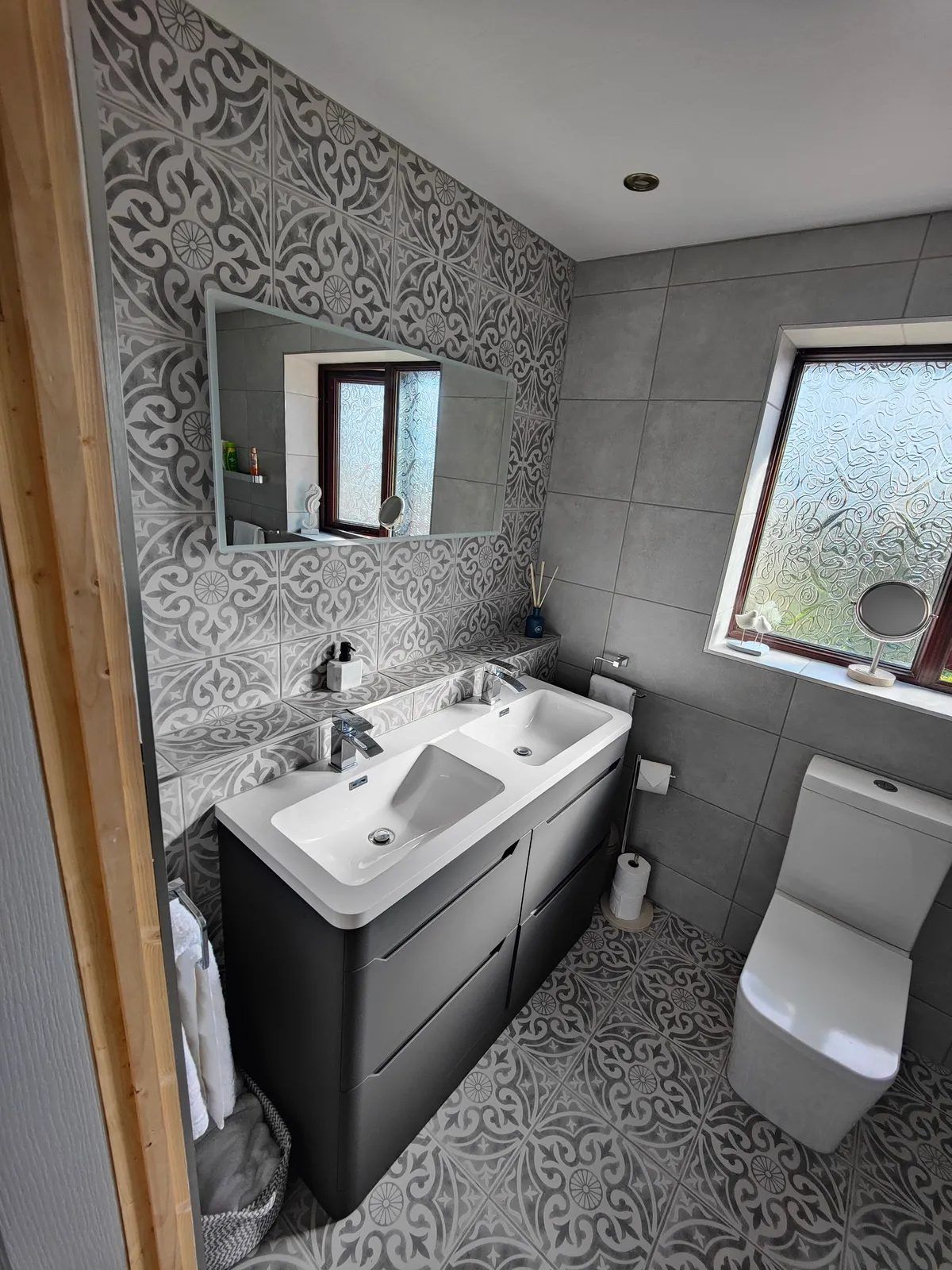 Bathroom with patterned feature wall and twin basins