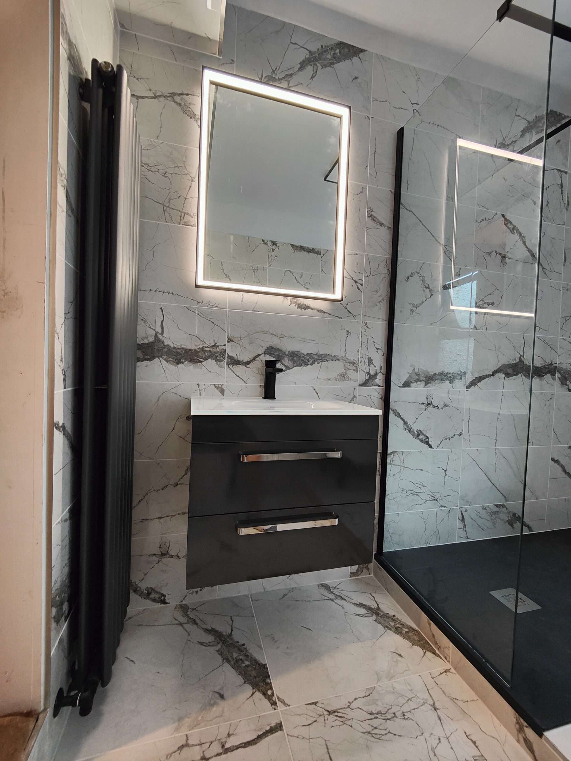 Marble-effect bathroom with vanity unit and LED mirror