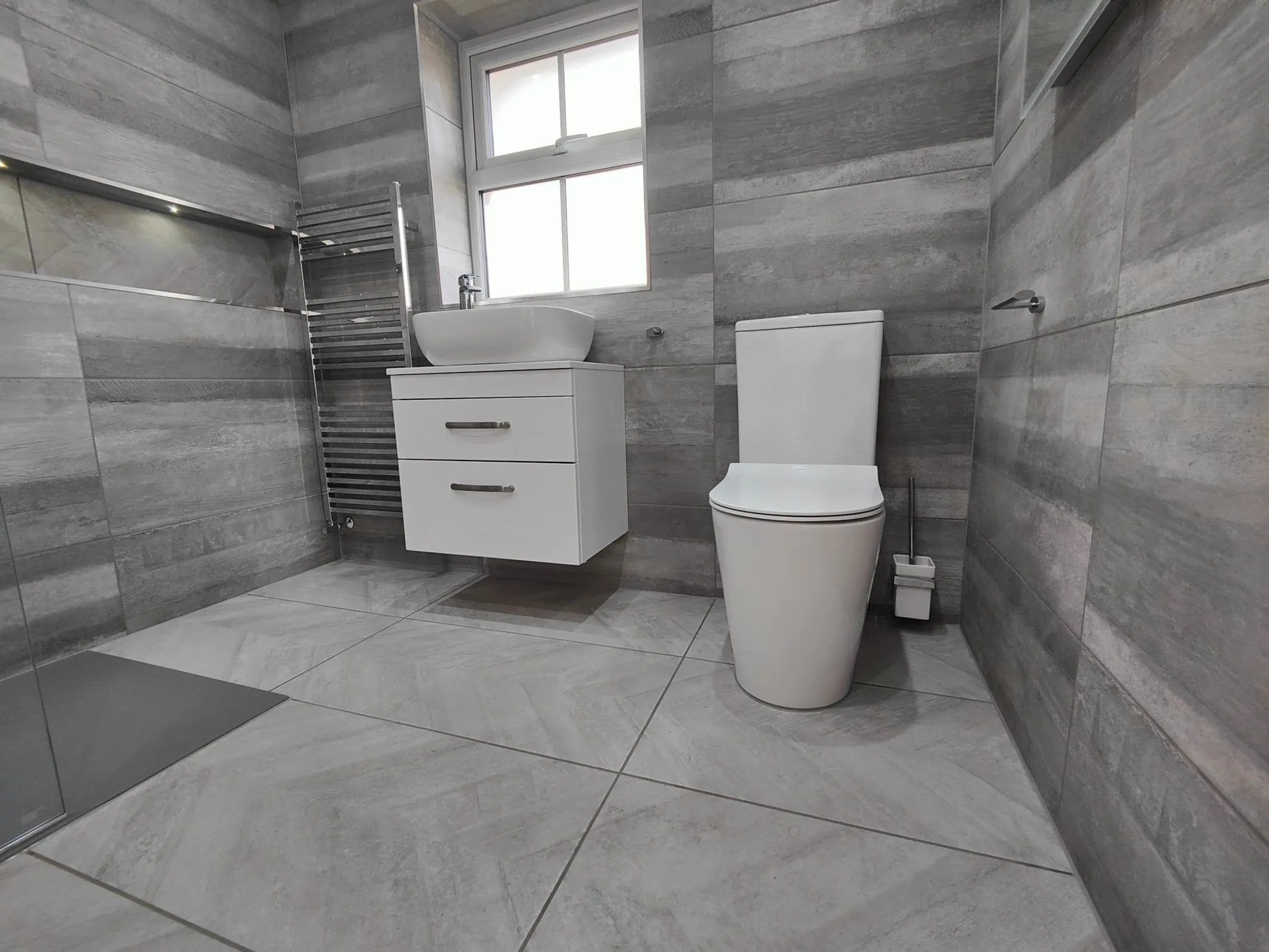 Bright walk-in shower with floating vanity