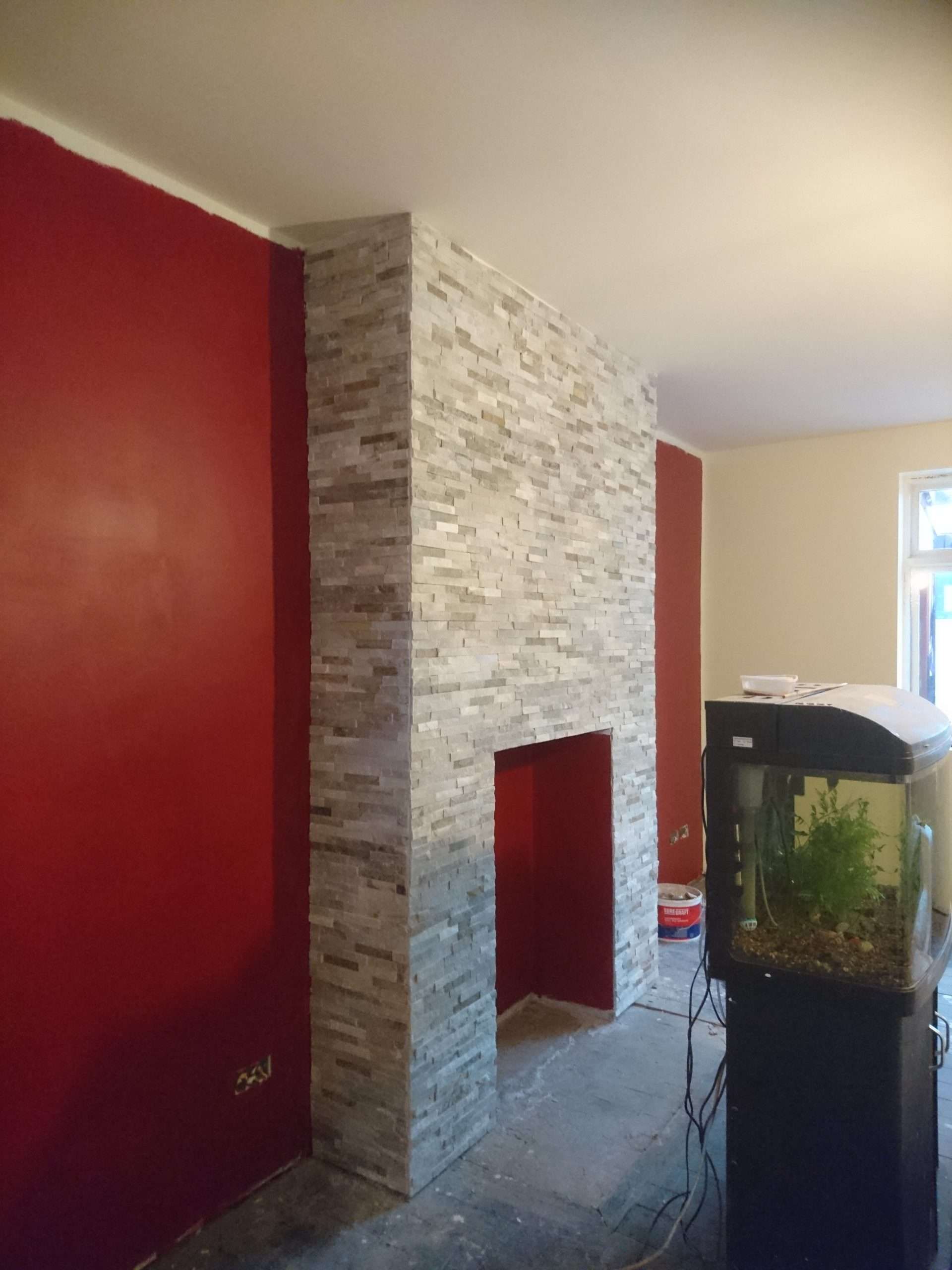 Feature wall with stone cladding and wood-effect flooring