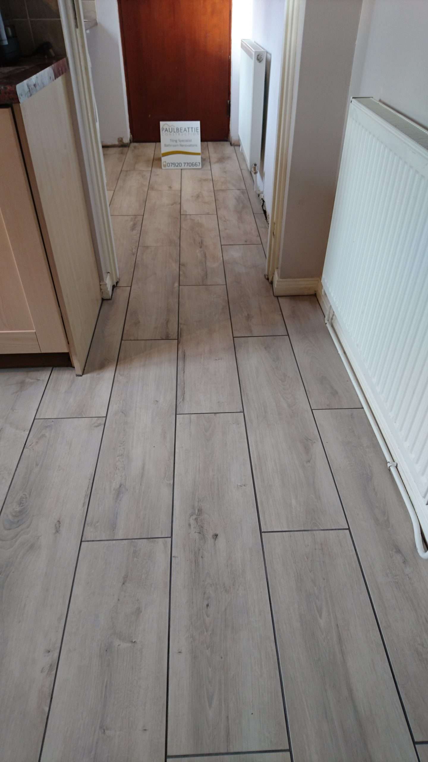 Wood-effect flooring fitted through a hallway