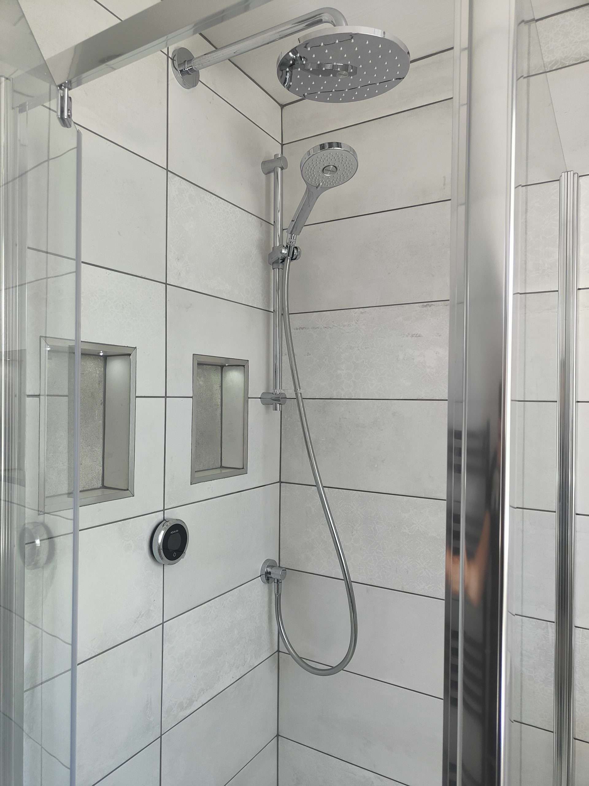 White-tiled walk-in shower with rainfall head